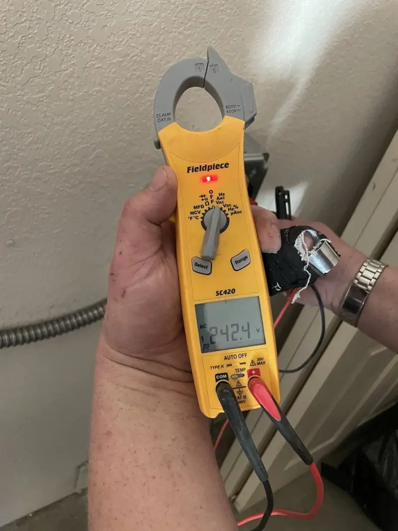 Voltage testing with clamp meter during Ceiling Fan Installation in Denmark